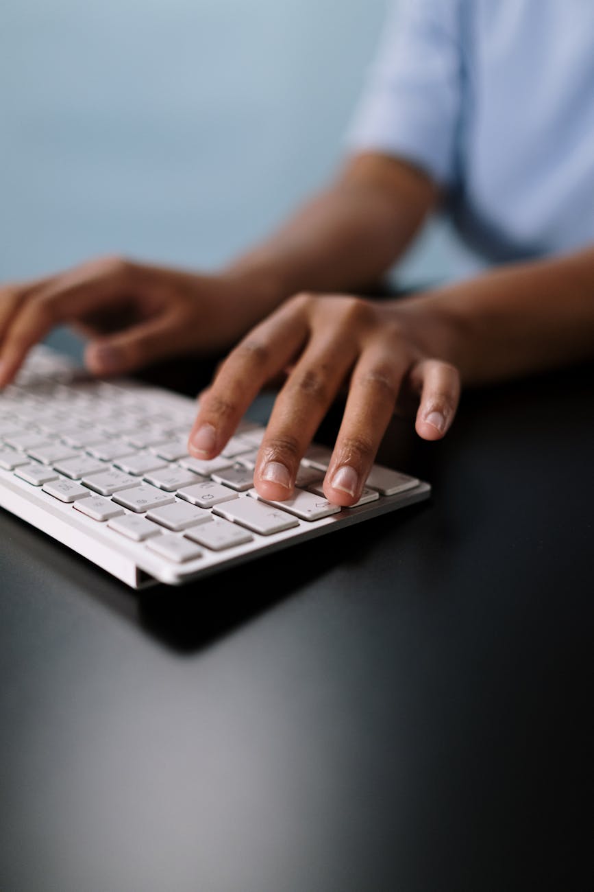Person typing on a computer keyboard
