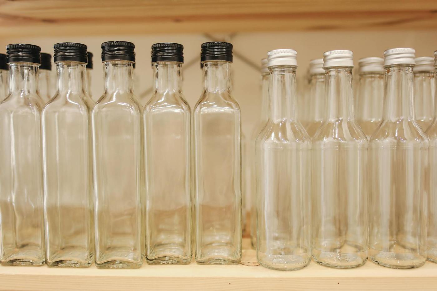 Shelf with a row of empty glass bottles