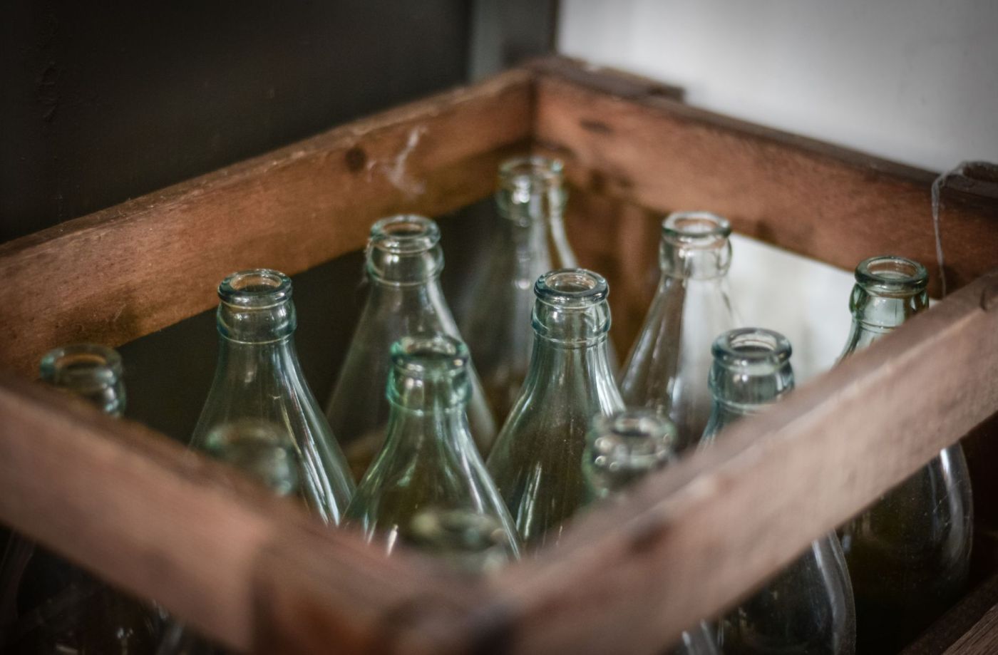 Empty glass pop bottles are sitting in crate